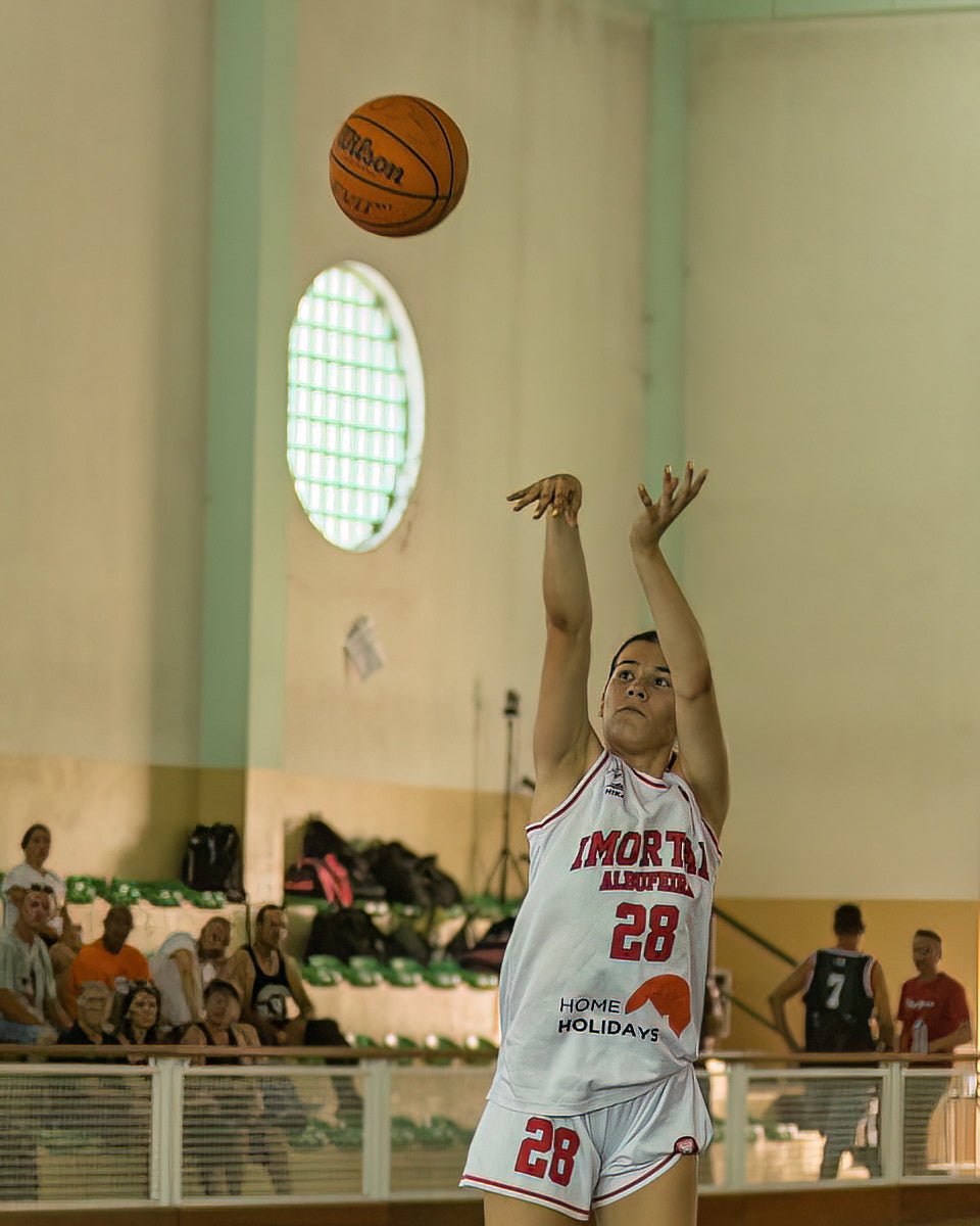 Basketball player in action during a game with a Wilson basketball.