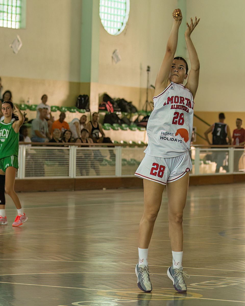 Basketball player in action on a court with spectators in the background