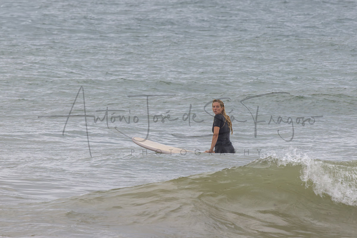A man in a black wetsuit standing in ocean water with a wave in the foreground, overlaid with a large photographer's watermark reading 'António José de Silva Fragoso Photography'.