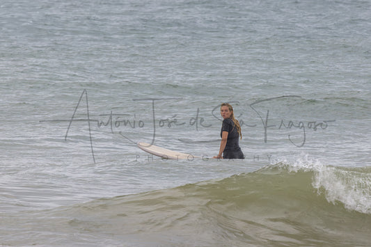 A man in a black wetsuit standing in ocean water with a wave in the foreground, overlaid with a large photographer's watermark reading 'António José de Silva Fragoso Photography'.