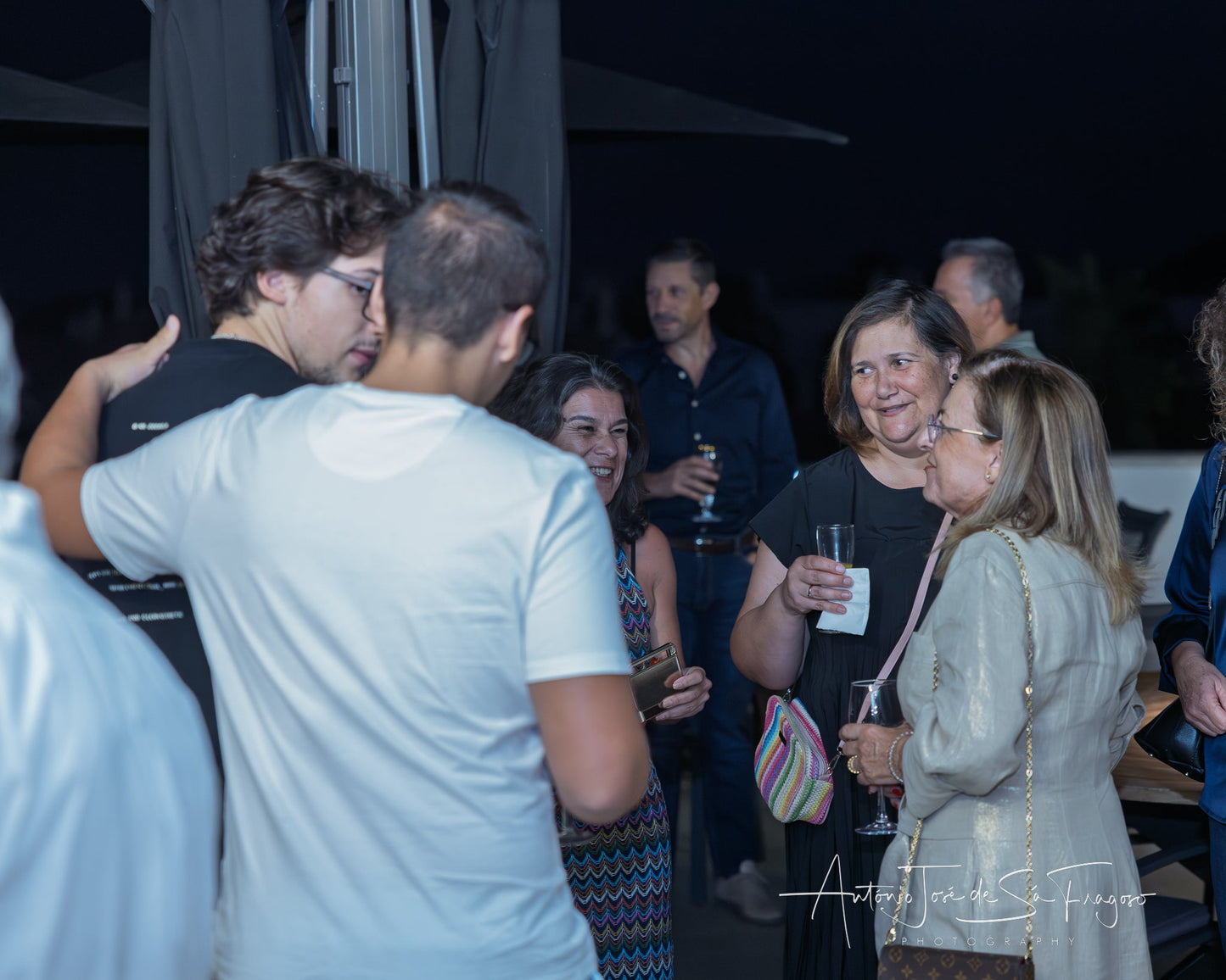 People socializing in a stylish indoor setting with balloons and decor.