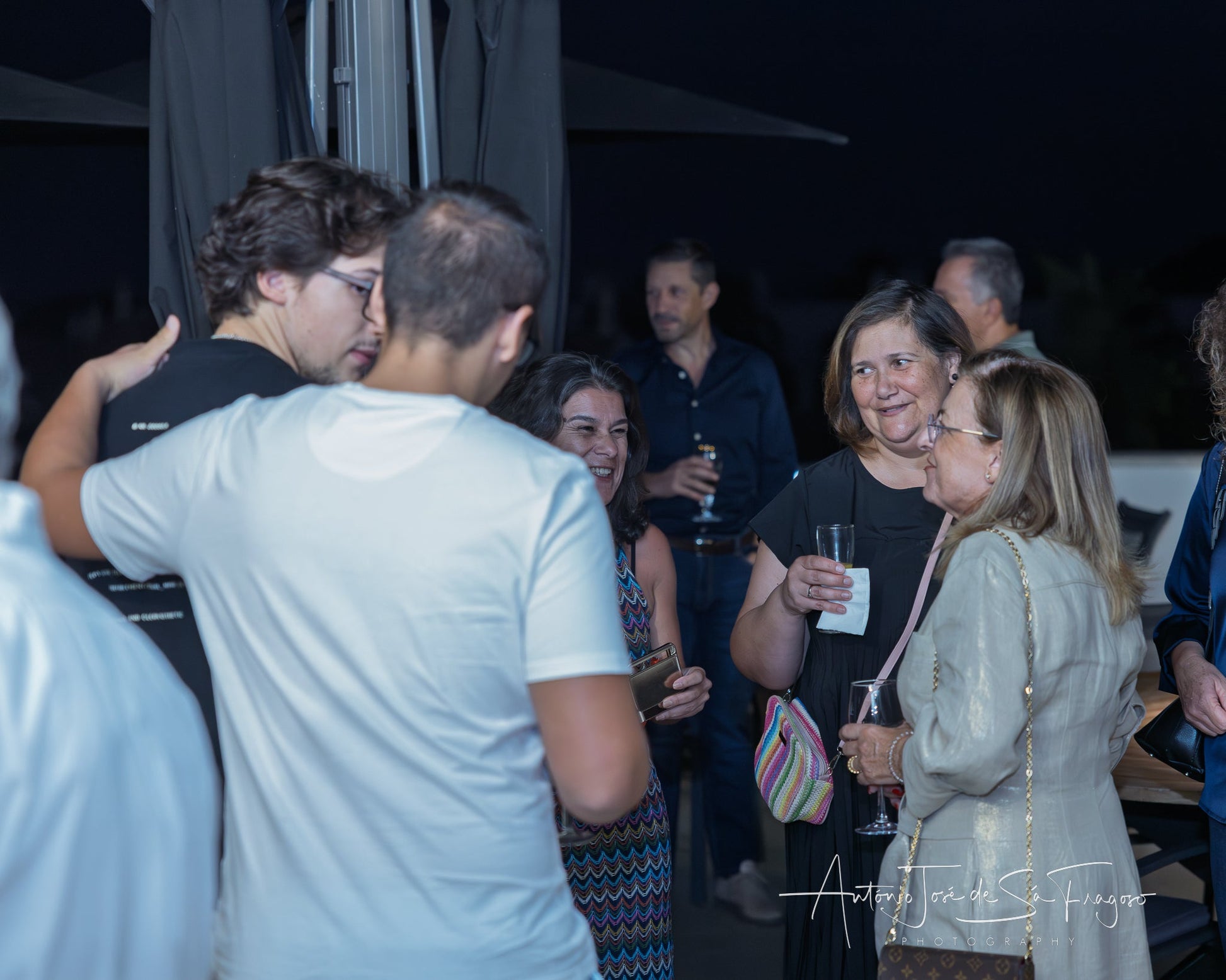 People socializing in a stylish indoor setting with balloons and decor.