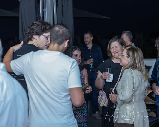 People socializing in a stylish indoor setting with balloons and decor.