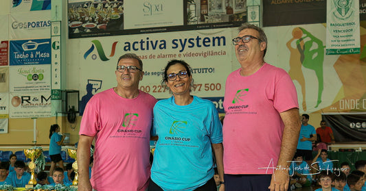 Three people standing together with promotional banners in the background