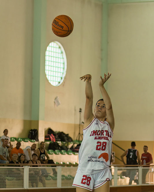 Basketball player in action during a game with a Wilson basketball.