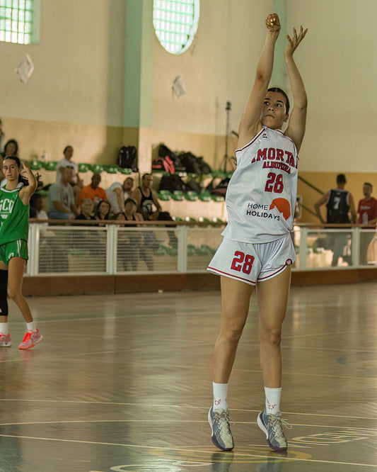 Basketball player in action on a court with spectators in the background